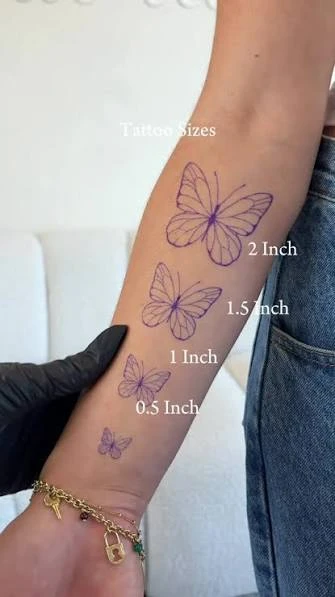 Tattoo size comparison showing butterfly designs at 0.5, 1, 1.5, and 2 inches on a forearm